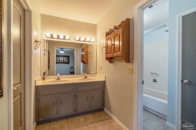 bathroom with vanity, tile patterned floors, and a textured ceiling