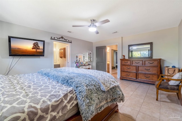 tiled bedroom with ceiling fan and ensuite bathroom