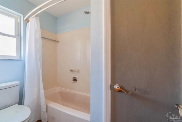 bathroom featuring toilet and shower / bathtub combination with curtain