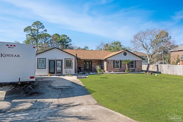 ranch-style house featuring a front lawn