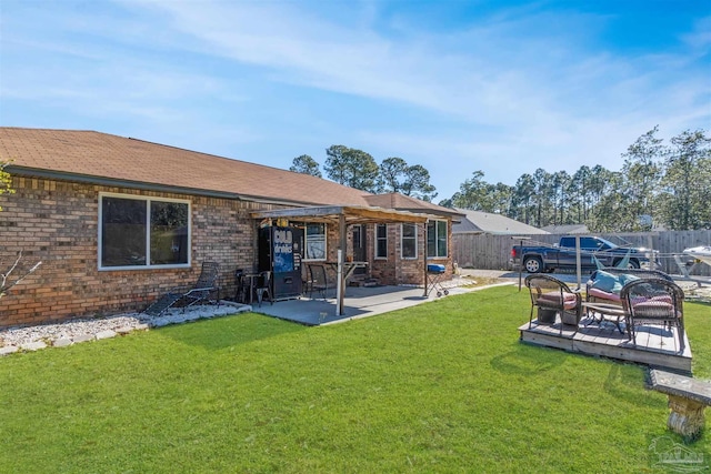 rear view of property with a patio area and a lawn