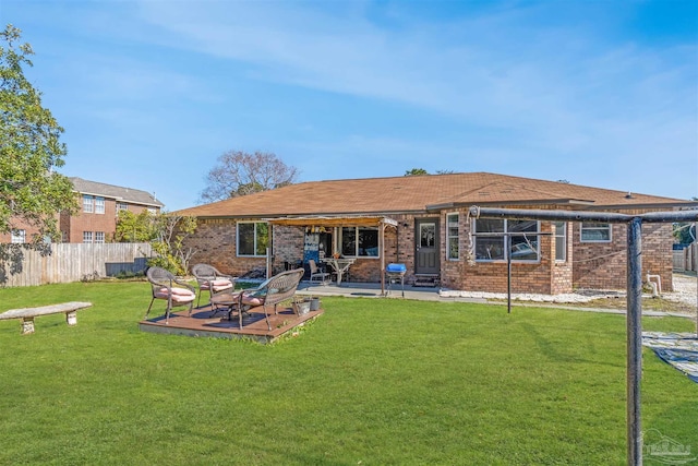 rear view of property with a patio area and a lawn