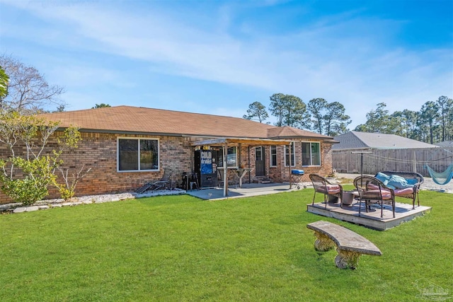 rear view of property featuring a patio area and a yard