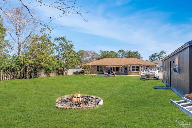 view of yard with an outdoor fire pit and cooling unit