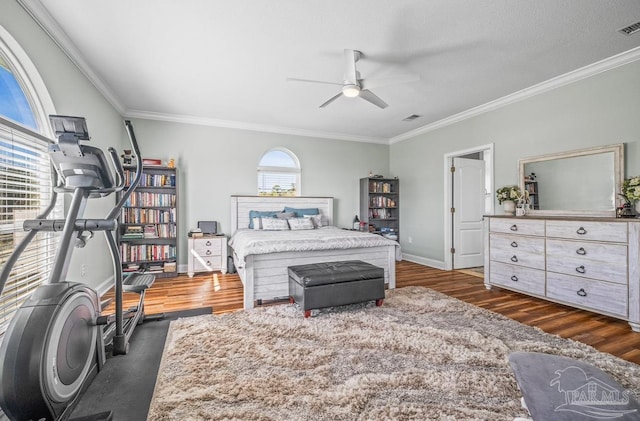 bedroom featuring ornamental molding, dark hardwood / wood-style floors, and ceiling fan