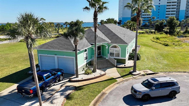 view of front of property featuring a garage and a front lawn