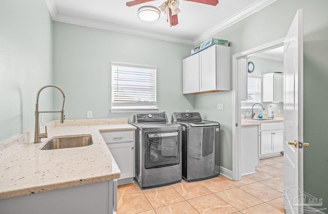 washroom with independent washer and dryer, crown molding, cabinets, and sink