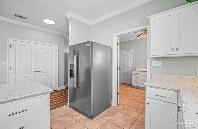 kitchen featuring high quality fridge, crown molding, white cabinetry, and ceiling fan