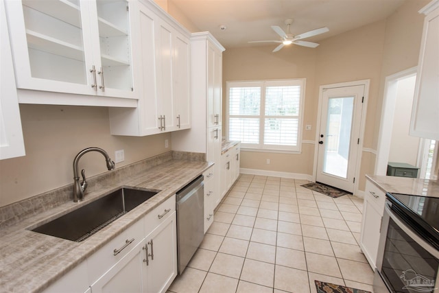 kitchen featuring sink, white cabinets, light tile patterned floors, light stone counters, and stainless steel appliances