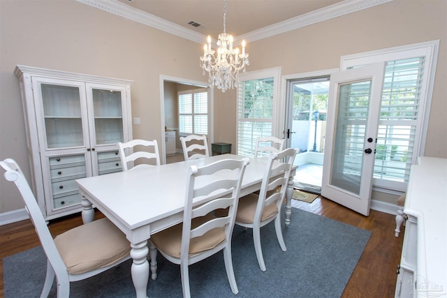 dining space with a notable chandelier, ornamental molding, dark hardwood / wood-style floors, and french doors