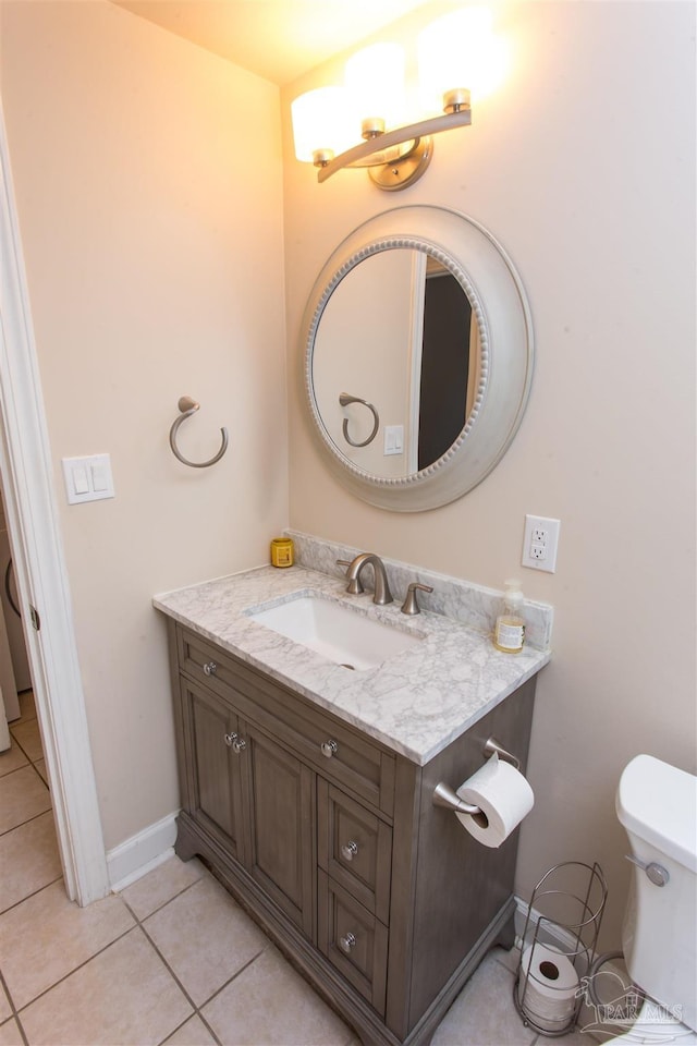 bathroom with vanity, toilet, and tile patterned flooring