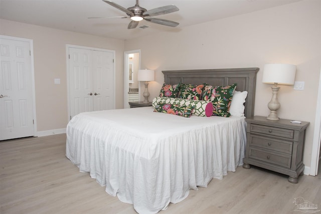 bedroom featuring a closet, ensuite bathroom, ceiling fan, and light hardwood / wood-style flooring