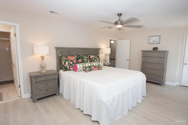 bedroom with connected bathroom, light hardwood / wood-style flooring, and ceiling fan