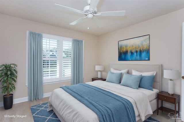 bedroom with ceiling fan and light hardwood / wood-style flooring