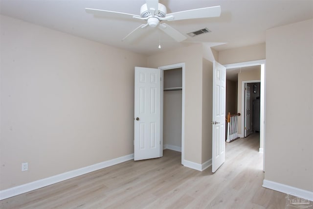 unfurnished bedroom featuring light hardwood / wood-style floors and a closet