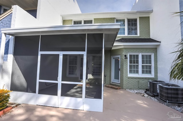 doorway to property featuring central AC and a patio area