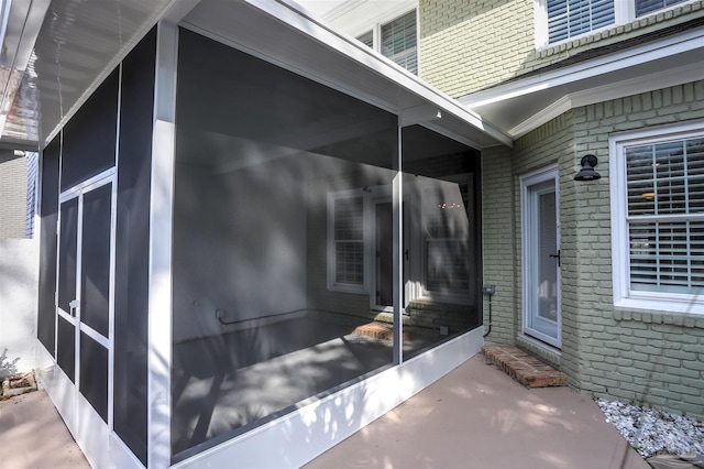 view of property exterior with a sunroom