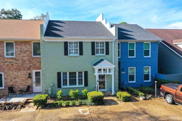 colonial home with a patio