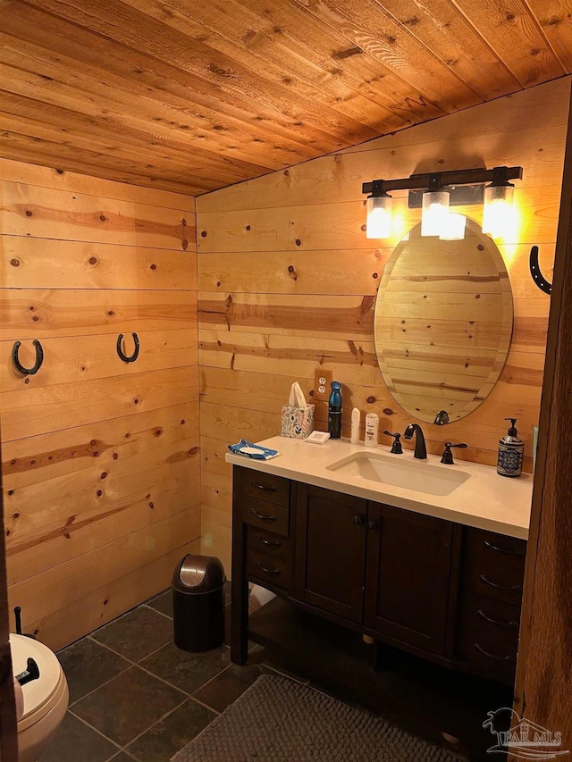 bathroom featuring tile patterned flooring, vanity, wood ceiling, and wooden walls