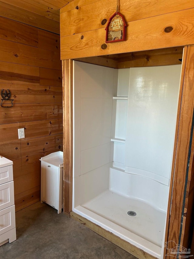 bathroom featuring vanity, walk in shower, wooden walls, and wood ceiling