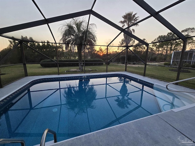 pool at dusk with glass enclosure, an outdoor pool, and a lawn