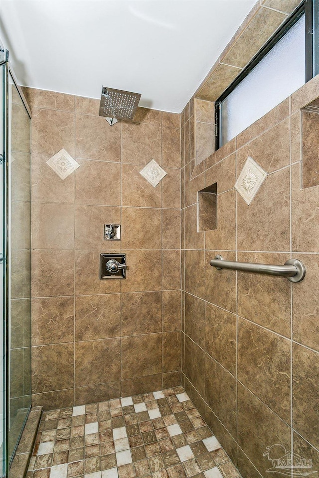 bathroom with a tile shower