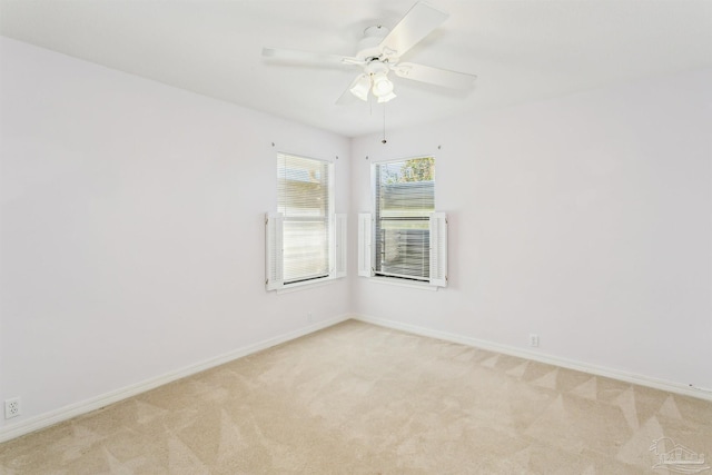 unfurnished room with light carpet, ceiling fan, and baseboards