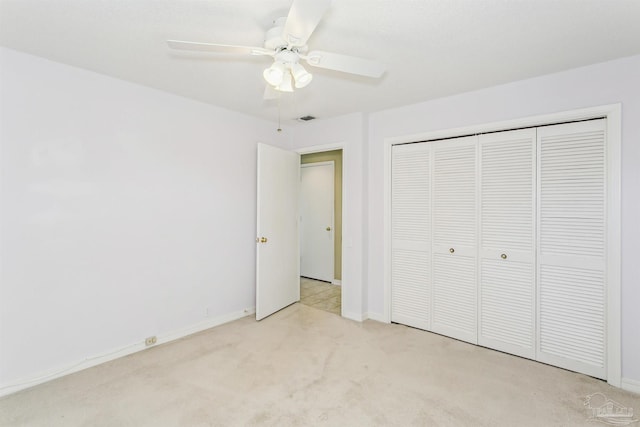 unfurnished bedroom with baseboards, visible vents, a closet, and light carpet