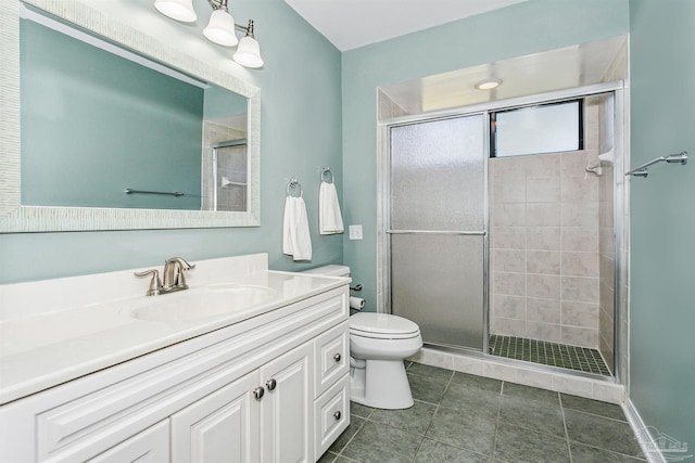 full bathroom featuring vanity, a shower stall, toilet, and tile patterned flooring