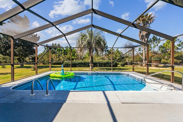 pool featuring glass enclosure, a lawn, and a patio area