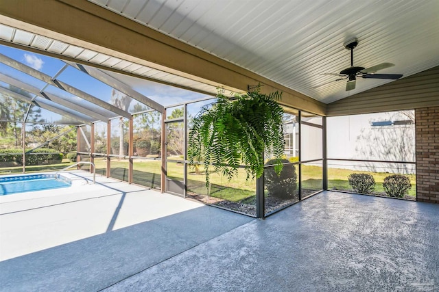 unfurnished sunroom with ceiling fan and vaulted ceiling