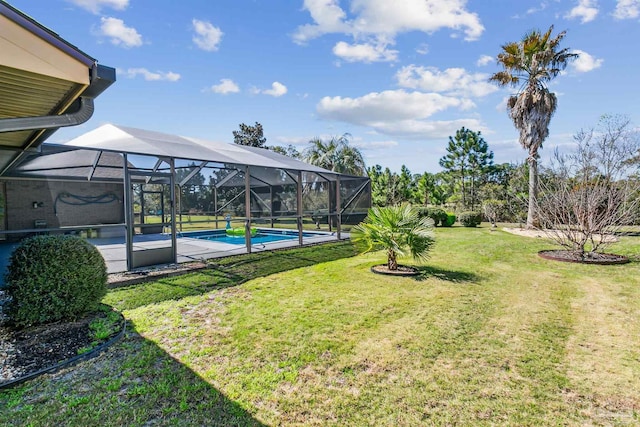 view of yard featuring a lanai and an outdoor pool