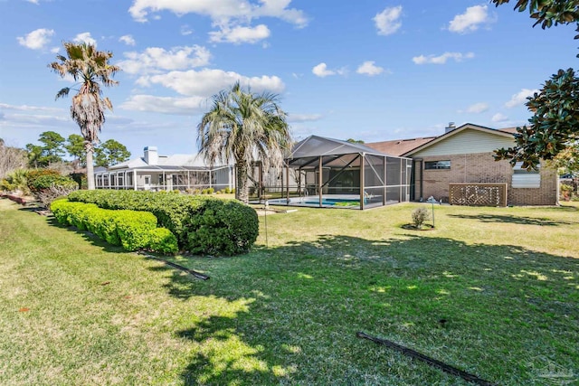 view of yard featuring a lanai and an outdoor pool