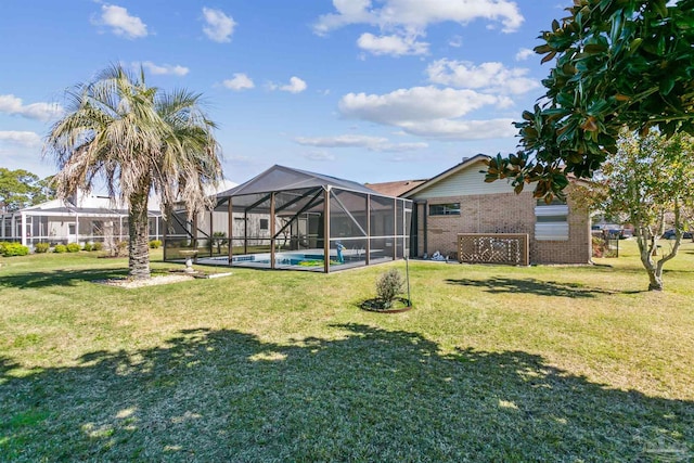 view of yard featuring a lanai and an outdoor pool