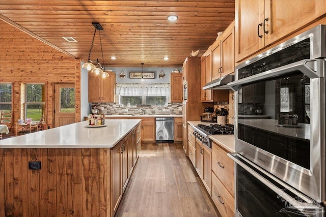 3351 Velor Rd, Mcdavid, FL 32568 - kitchen featuring wooden ceiling, under cabinet range hood, backsplash, light wood-style flooring, and appliances with stainless steel finishes