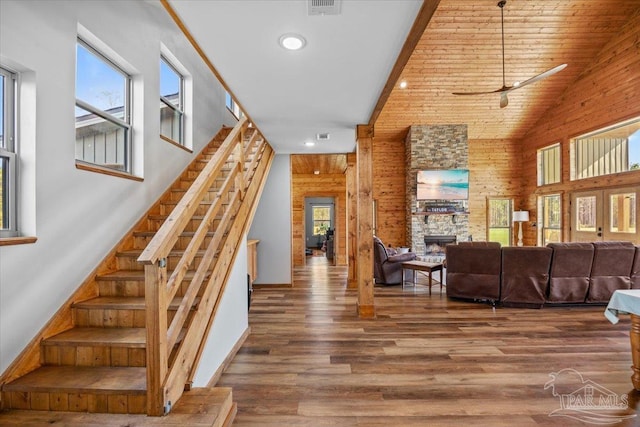 3351 Velor Rd, Mcdavid, FL 32568 - staircase with high vaulted ceiling, ceiling fan, visible vents, a fireplace, and wood finished floors