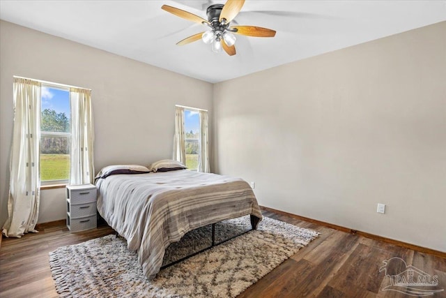 3351 Velor Rd, Mcdavid, FL 32568 - bedroom featuring baseboards, wood finished floors, multiple windows, and a ceiling fan