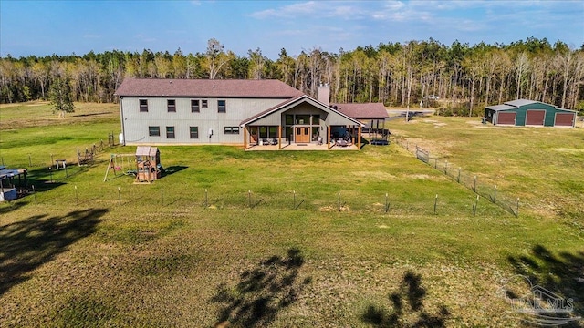 3351 Velor Rd, Mcdavid, FL 32568 - back of house featuring an outbuilding, fence, a patio, a lawn, and a forest view
