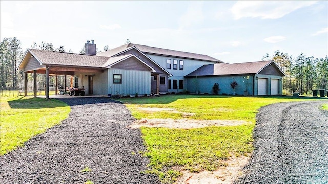3351 Velor Rd, Mcdavid, FL 32568 - view of front of house featuring a front lawn, a chimney, and a garage