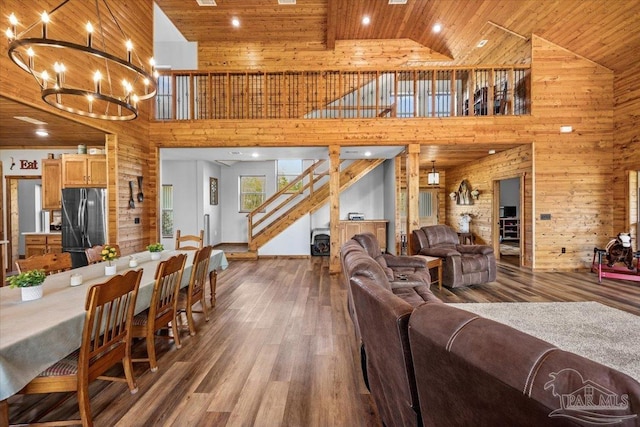3351 Velor Rd, Mcdavid, FL 32568 - living room with a notable chandelier, wood ceiling, stairway, wood finished floors, and wood walls