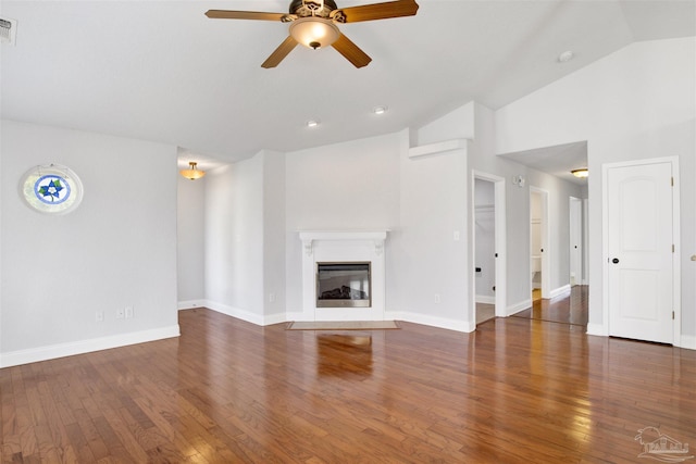 unfurnished living room featuring ceiling fan, dark hardwood / wood-style flooring, and vaulted ceiling