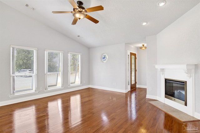 unfurnished living room featuring hardwood / wood-style floors, a textured ceiling, vaulted ceiling, and ceiling fan