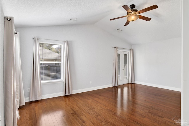 unfurnished room featuring ceiling fan, lofted ceiling, a textured ceiling, and dark hardwood / wood-style flooring