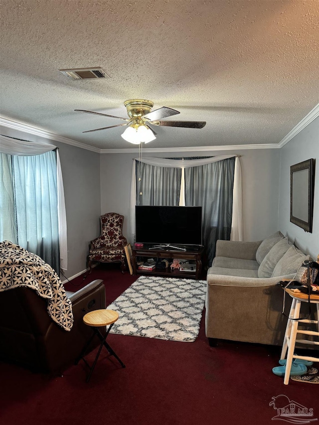 living room with a textured ceiling, ceiling fan, and crown molding