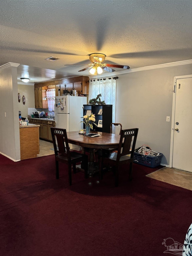 carpeted dining area with a wealth of natural light and a textured ceiling