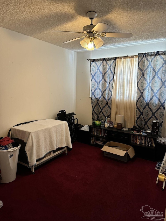 bedroom with carpet flooring, ceiling fan, and a textured ceiling