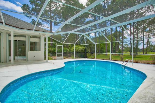 swimming pool featuring a patio and glass enclosure