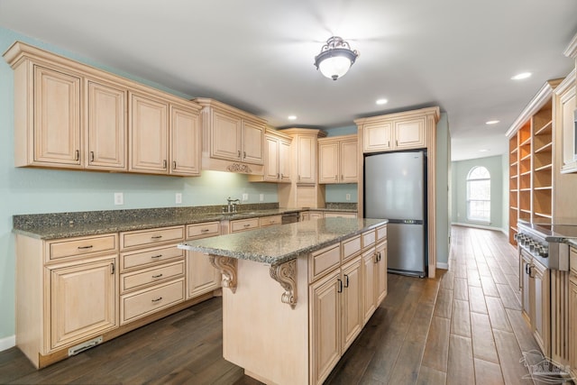 kitchen featuring a kitchen island, sink, a kitchen breakfast bar, stainless steel appliances, and dark wood-type flooring