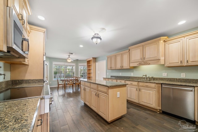 kitchen with light brown cabinetry, sink, a center island, dark hardwood / wood-style flooring, and stainless steel appliances