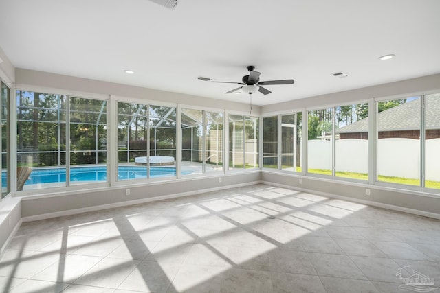 unfurnished sunroom with ceiling fan and plenty of natural light